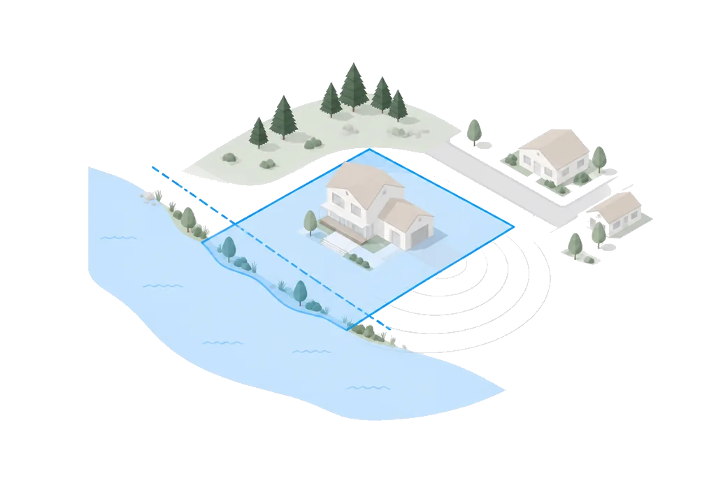 A lot at the edge of a river with a dashed flood line across one corner.
